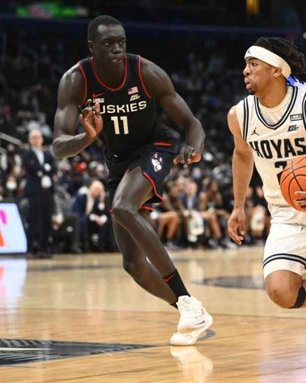 Feb 27, 2022; Washington, District of Columbia, USA; Georgetown Hoyas guard Dante Harris (2) dribbles as Connecticut Huskies forward Akok Akok (11) defends during the first half at Capital One Arena. Mandatory Credit: Brad Mills-USA TODAY Sports